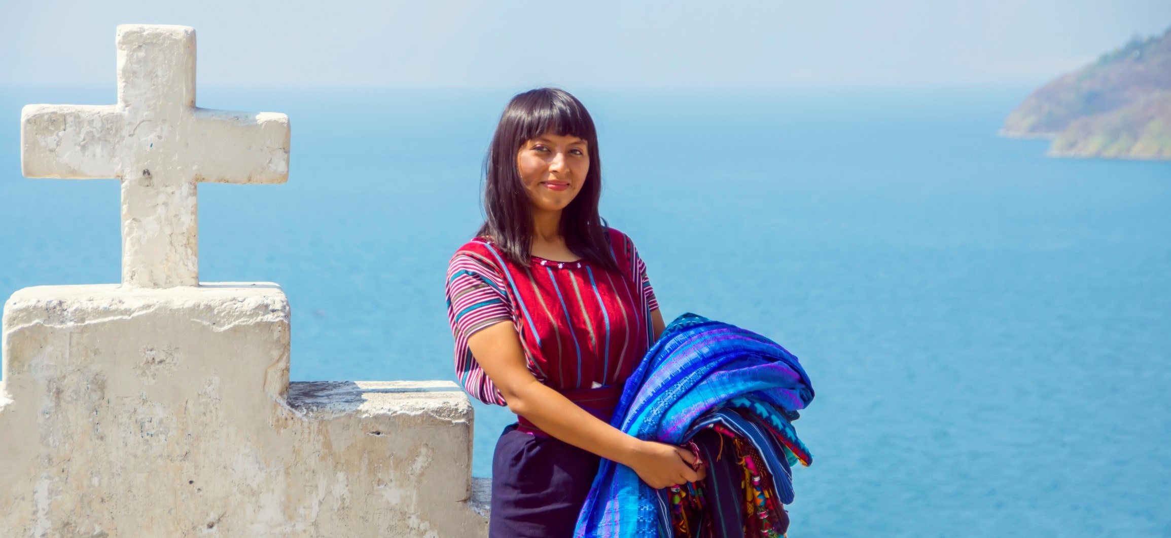 woman stands in front of cross in guatemala woman stands in front of cross in guatemala